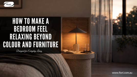 Modern Australian bedroom with warm layered lighting, organised bedside table and natural textures creating a calm evening atmosphere.
