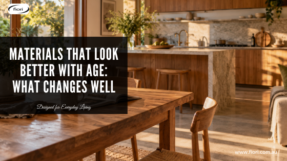 Established Australian kitchen and dining area with warm timber, natural stone and subtly aged surfaces in soft late-afternoon light.