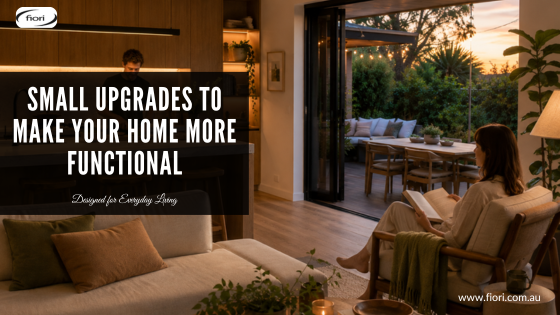Warm contemporary Australian open-plan home with someone preparing food in the kitchen while another person relaxes nearby and the outdoor area remains connected and inviting.