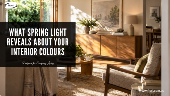 Sunlit Australian living room with warm timber, textured upholstery and spring daylight moving across the interior.